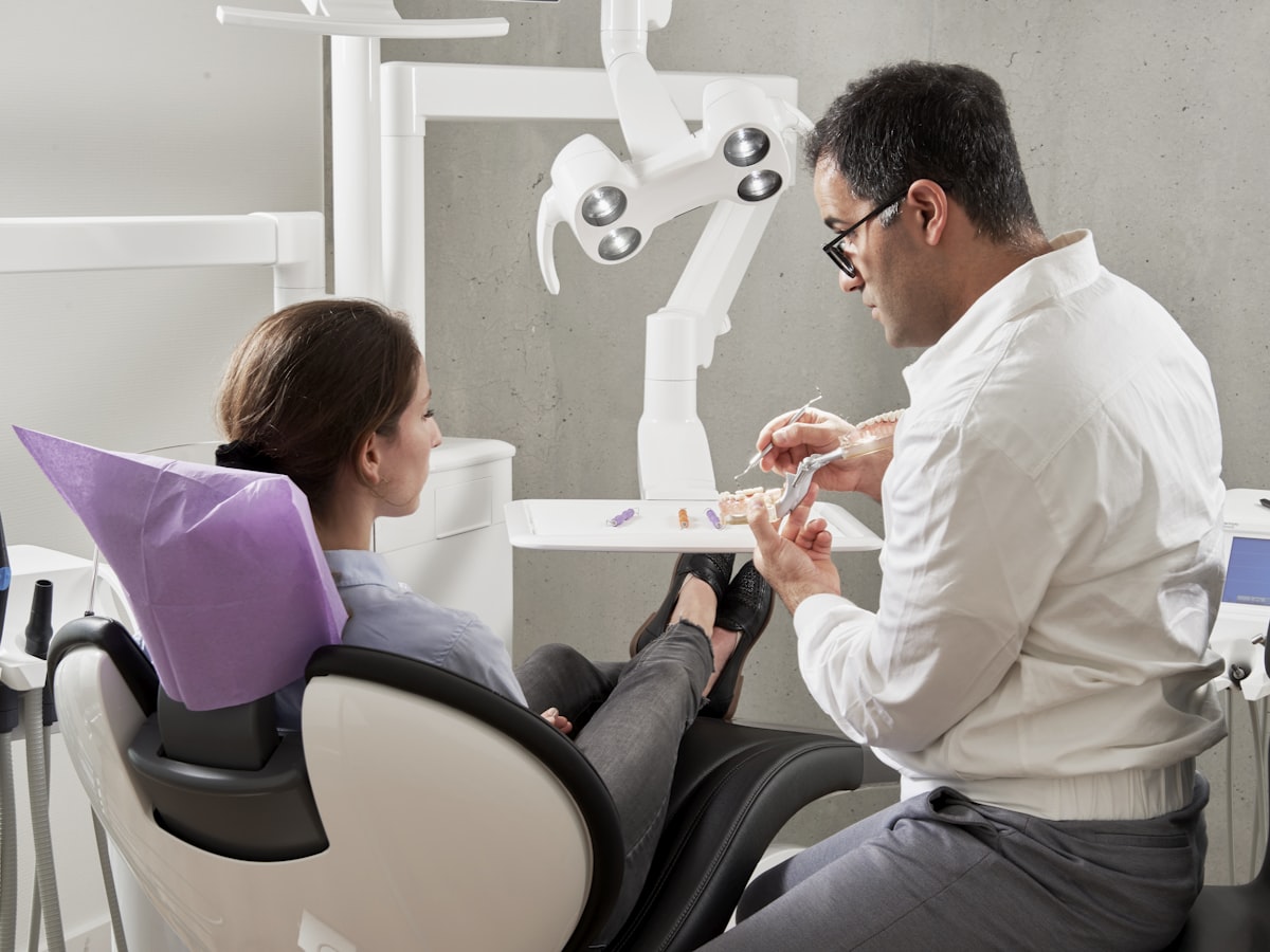 Emergency dentist treating a patient at Genesis Dental Centre in SW Calgary